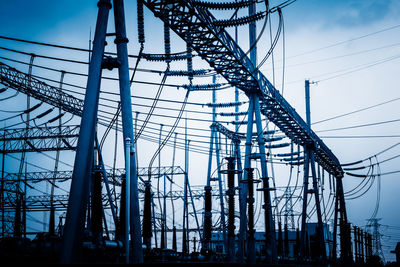 Low angle view of electricity pylon against sky