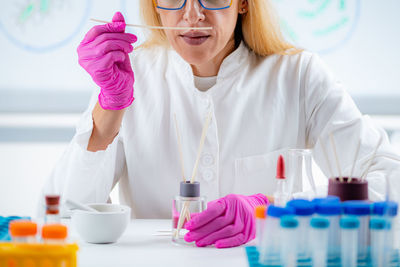 Perfumer holding a stick with aromatic oil.