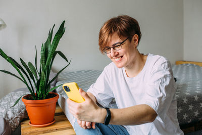 Woman using mobile phone at home