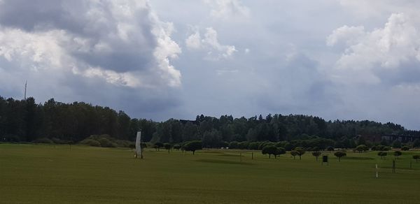 Panoramic view of trees on field against sky