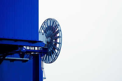 Low angle view of large machinery against clear sky