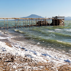 Pier over sea against clear sky