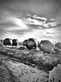 Stack of hay on field against sky