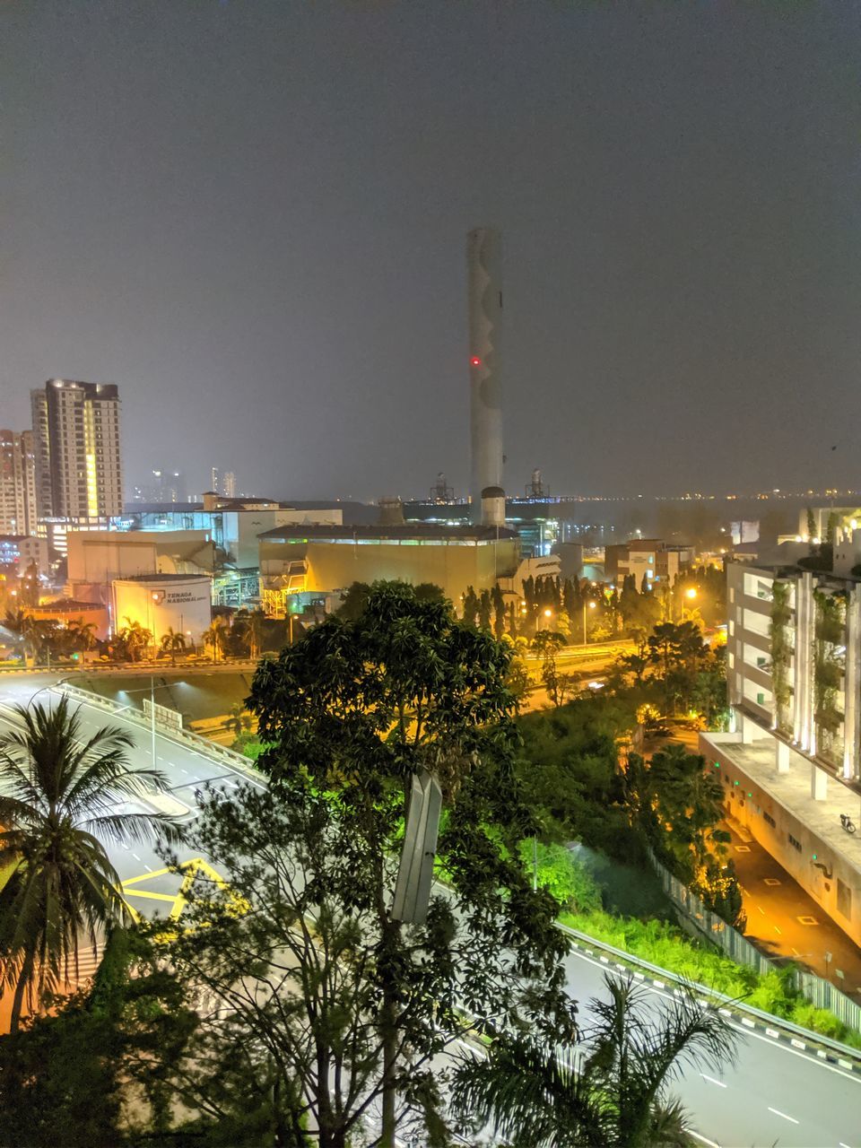 ILLUMINATED BUILDINGS IN CITY AGAINST SKY