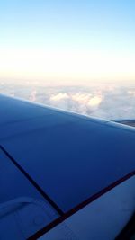 Cropped image of airplane flying over sea