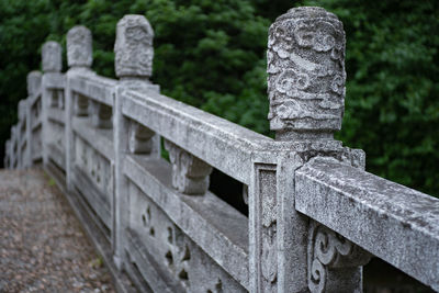 Close-up of stone cross in cemetery