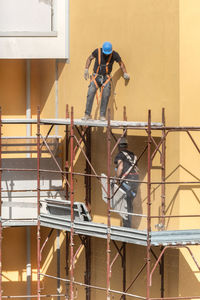 Man working on construction site against building