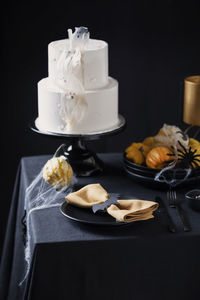 Close-up of cake on table against black background