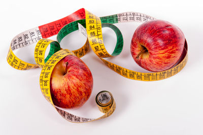 High angle view of fruits and apple on white background