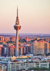 View of buildings in city at sunset