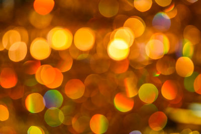 Defocused image of illuminated christmas lights at night