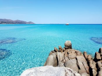 Scenic view of sea against clear blue sky