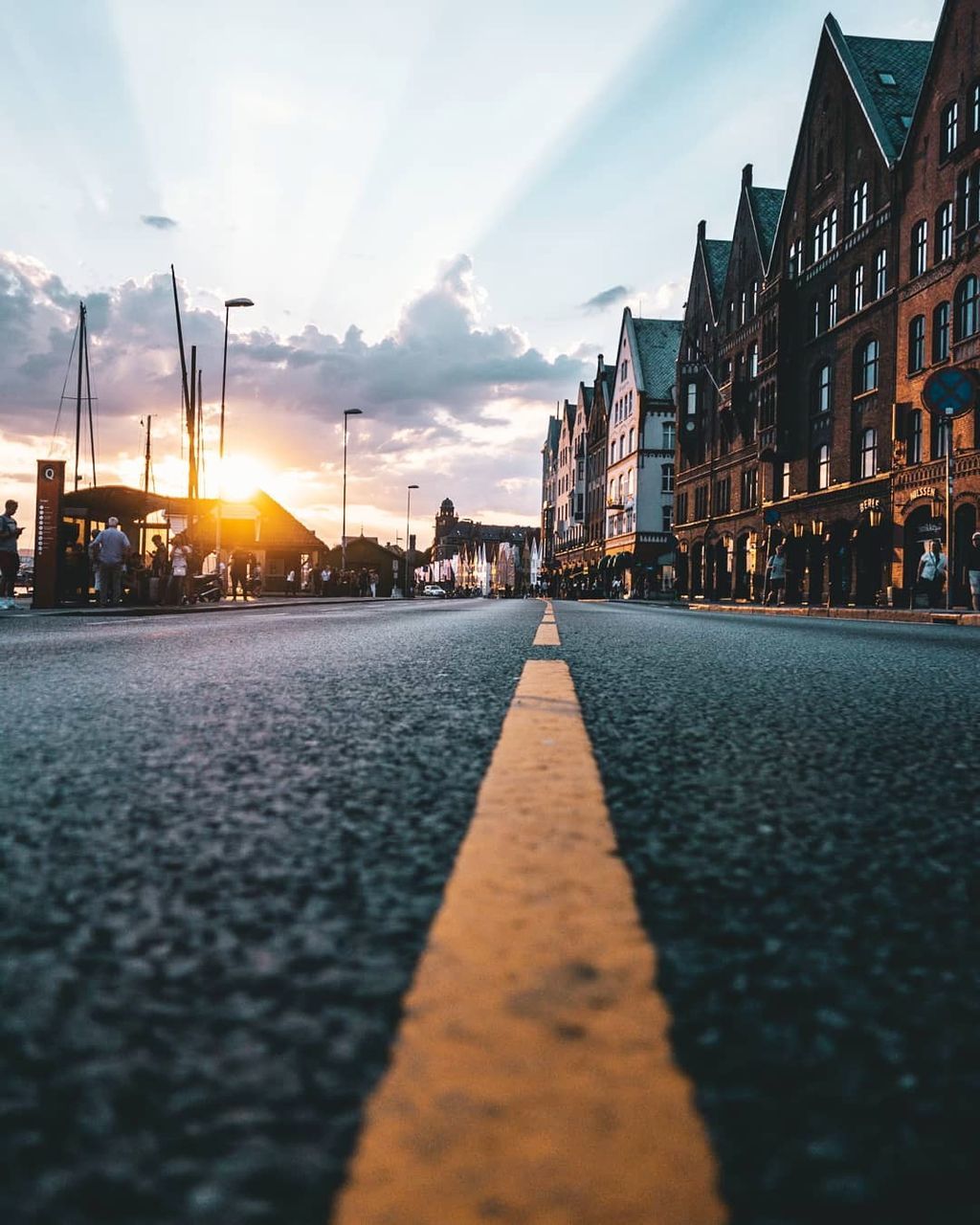 sky, building exterior, built structure, architecture, sunset, city, cloud - sky, nature, surface level, road, transportation, street, sunlight, no people, building, outdoors, sun, diminishing perspective, orange color, selective focus