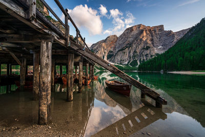 Wooden structure in lake against sky