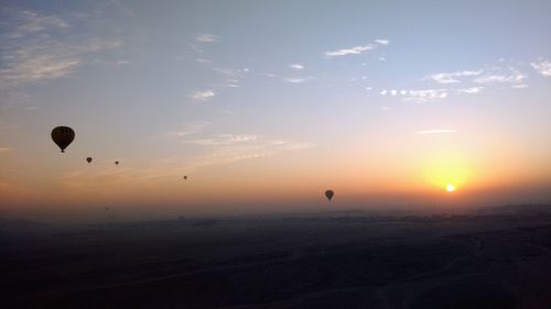 Silhouette of hot air balloon against sky during sunset