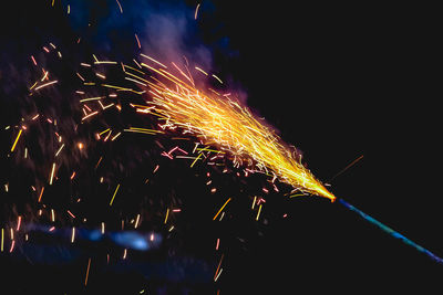 Low angle view of firework display at night