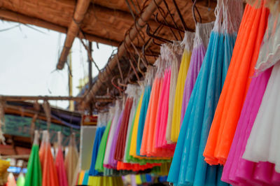 Low angle view of multi colored candles hanging in row