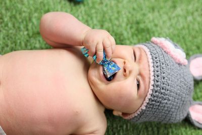 High angle view of baby girl on field