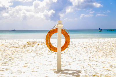 Life belt on wooden post at beach