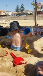 Boy playing with sand at beach