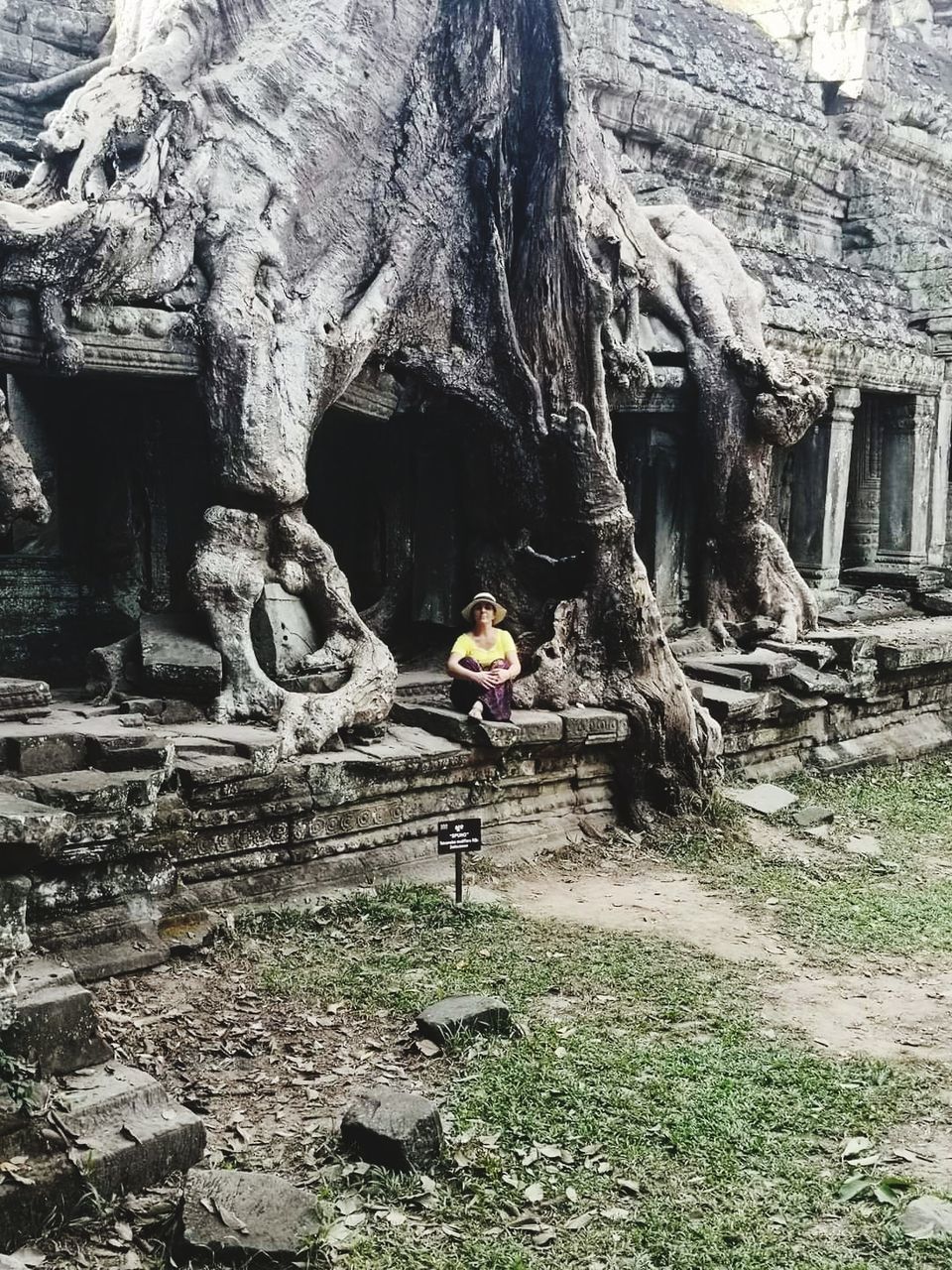 cave, one person, architecture, leisure activity, nature, lifestyles, day, built structure, full length, adult, rock, men, history, women, outdoors, ruins, plant, land, the past, sitting, ancient, tree, rock formation, travel, geology, ancient history, old ruin, young adult, building, religion, activity, female