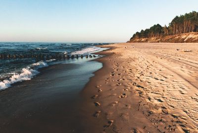 Scenic view of beach against clear sky