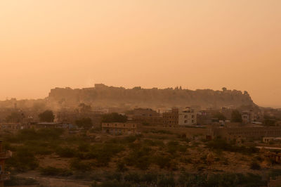 High angle view of buildings against sky during sunset