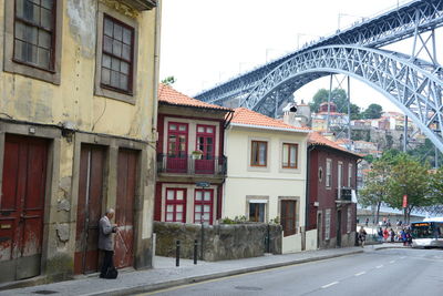 People on street amidst buildings in city