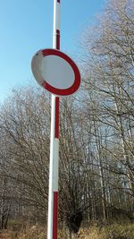 Low angle view of road sign against clear sky