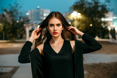 Portrait of beautiful young woman at night