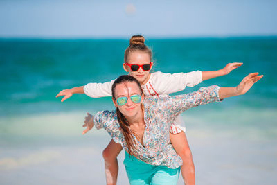 Low section of woman wearing sunglasses on beach