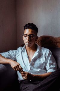 Portrait of young man sitting on table