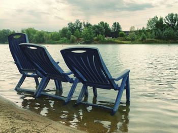 Empty bench in lake