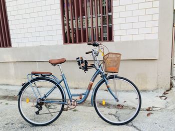 Mommy bicycle parked against wall