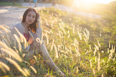 Young woman sitting on field