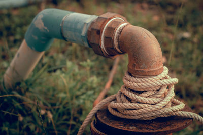 Close-up of rope tied up on metal