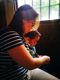 Midsection of mother and daughter at home