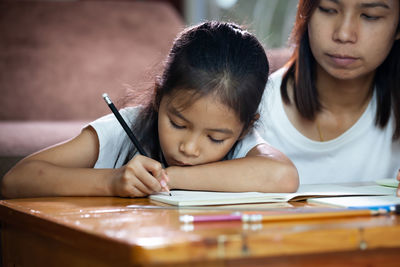 Mother helping daughter in study