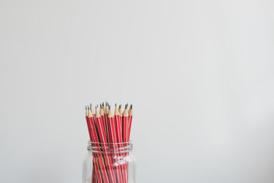 Close-up of colored pencils against white background