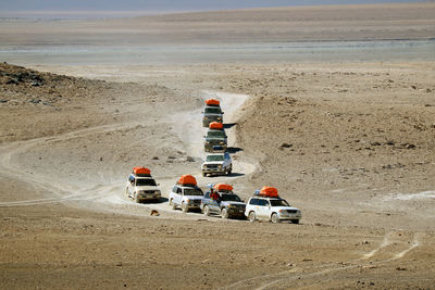 Group of camper vans running on the desert road, eduardo avaroa andean fauna, potosi, bolivia