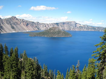 Scenic view of sea and mountains against sky