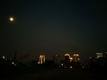 Illuminated buildings in city at night