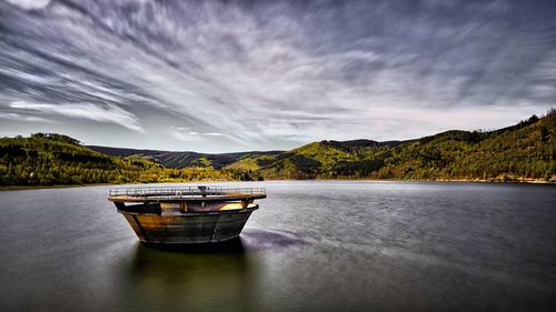 Boat in lake against sky