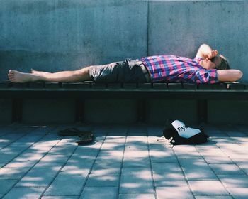 Full length of man relaxing on seat