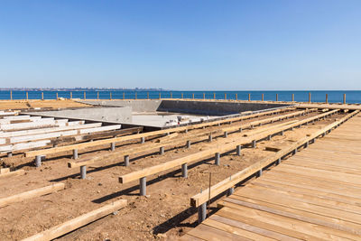 Scenic view of beach against clear blue sky