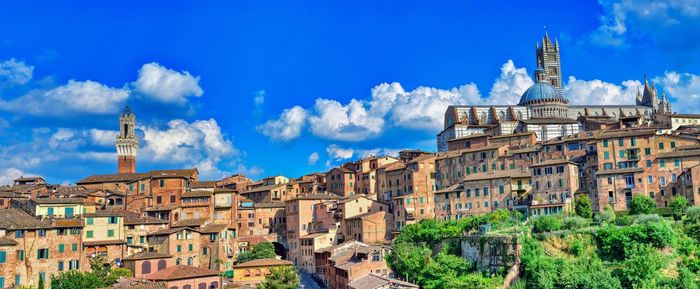 Panoramic view of buildings in city against sky