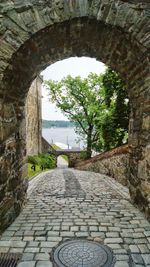 Narrow walkway leading to archway