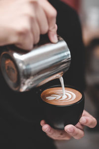 Midsection of person holding coffee cup