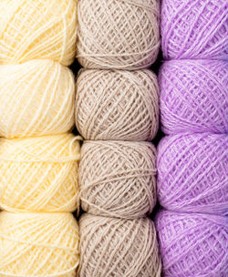 Knitting needles, colorful threads. selection of pastel colored yarn wool on shopfront. 