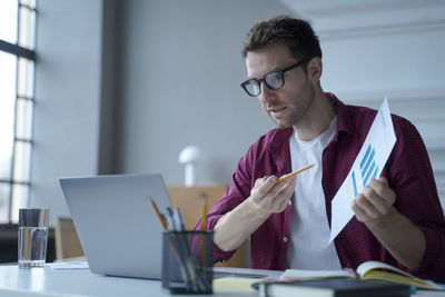 Young woman using laptop at office